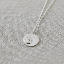 back of silver necklace, VS logo

