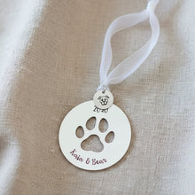 Decorative ornament with paw print on a Christmas tree