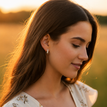 woman wearing Victoria & Sterling J Hoop Earrings