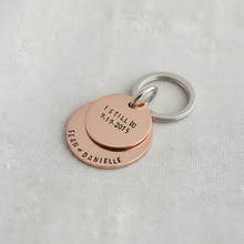 copper keychain with engraved text on a white dish