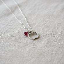 Silver necklace with apple and red bead charm 