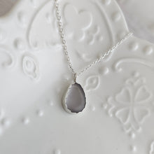 Silver necklace with a light purple glass pendant 