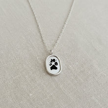 Silver necklace with a paw print pendant