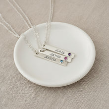 3 silver necklaces, with vertical pendants on chains with names
