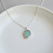 Necklace with a green jadeite scalloped bezel pendant 