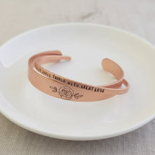 copper cuff bracelets with engraved text and rose design