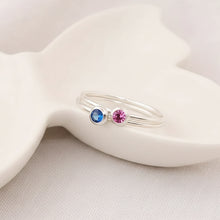 two Silver rings with blue and pink gemstones 