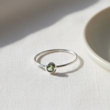 Silver ring with a green gemstone